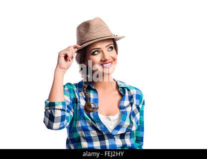 Frau mit Zopf in blau und grün überprüft Hemd lächelnd Stockfoto