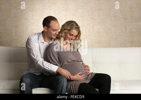 Schwangere Frau und Mann einander umarmen Stockfoto