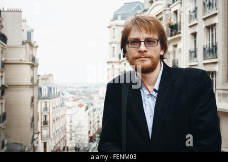 Schöner nachdenklich bärtigen Mann tragen Kopfhörer. Touristen im Urlaub in Paris, Frankreich. City-Lifestyle. Stockfoto