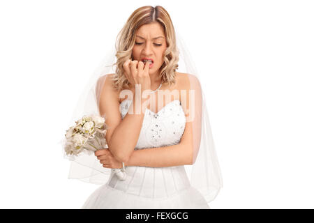 Nervöse Braut im weißen Hochzeitskleid beißen ihre Fingernägel isoliert auf weißem Hintergrund Stockfoto