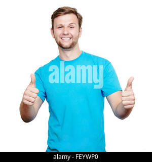 Lächelnder junge Mann Daumen auftauchen Stockfoto