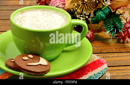 Tasse Cappuccino mit Kakao Kekse auf Holztisch Stockfoto