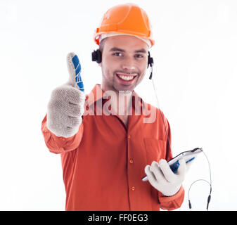 Ein Bauherr mit Telefon und geben einen Daumen nach oben. Stockfoto