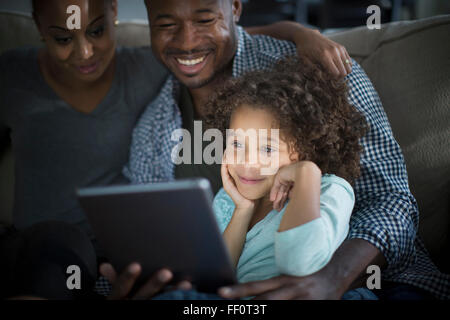 Familie mit digital-Tablette auf sofa Stockfoto