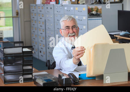 Kaukasische Geschäftsmann Einreichung Ordner im Büro Stockfoto