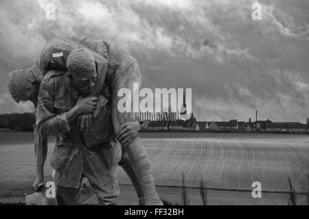 Überlagerte Schwarzweiß-Bild des 'Cobbers Denkmal seinen Gehilfen, die über die Felder mit Fromelles und Turm im Hintergrund. Stockfoto