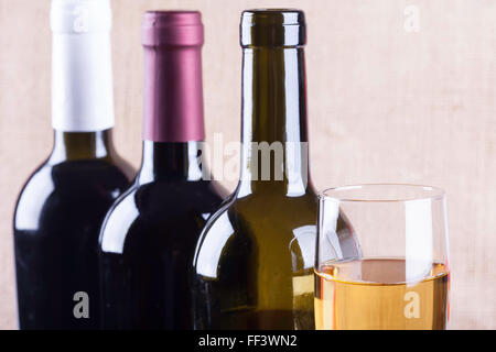 Glas Weißwein auf der Hintergrund-Flaschen Stockfoto