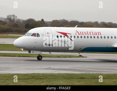 Austrian Airlines Fokker 100 mittelständische Twin-Turbinen-Kreiselbegläse Passagierflugzeug auf Manchester International Airport Asphalt Rollen. Stockfoto