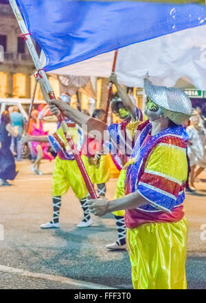 MONTEVIDEO, URUGUAY, kostümierte Januar - 2016 - Männer marschieren und die eine Flagge auf der konstituierenden Parade der Karneval von Montevide Stockfoto