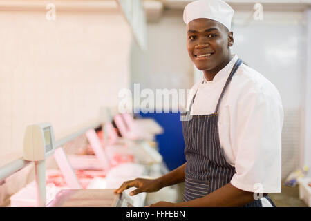 Portrait des afrikanischen stehend nahe bei Skala in Metzgerei Metzger Stockfoto