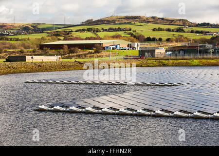 Die neue schwimmende solare Farm als Raster verbunden Godley Reservoir in Hyde, Manchester, UK. Das Schema ist ein 3-MW-System, bestehend aus 10.000 Photovoltaik-Paneele. Es wird United Utilities Stromrechnung auf der Kläranlage vor Ort, rund 7.000 £ pro Monat einsparen. Es ist die größte schwimmende solar Farm in Europa und der zweitgrößte in der Welt. Es liefert rund 33 % der Wasseraufbereitung Energiebedarf Pflanzen. Stockfoto