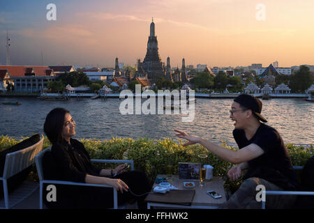 Paar Liebhaber. Landschaft bei Sonnenuntergang des Wat Arun Tempel von Chao Praya River vom Dach des Sala Rattanakosin Hotel. Bangkok Stockfoto