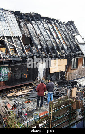 Hamburg, Deutschland. 15. Februar 2016. Zwei Leute betrachten gebrannt hinunter Gebäude des "Golden Pudel Club" in Hamburg, Deutschland, 15. Februar 2016. Club, einem berühmten Ort von der Hamburger Musik- und Kunstszene, wurde am Sonntag durch einen Brand zerstört. Foto: Daniel Reinhardt/Dpa/Alamy Live News Stockfoto