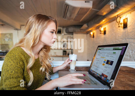 Blonde Frau mit Laptop-Computer im café Stockfoto