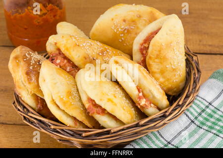 Pizza-Brötchen mit Würstchen und Peperoni in einem hölzernen Korb Stockfoto