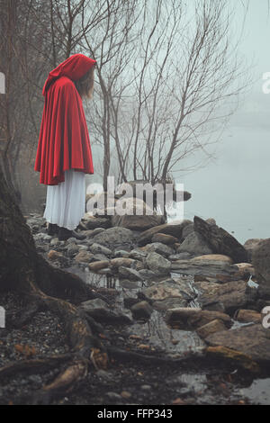 Dunkel und traurig Portrait einer rot mit Kapuze Frau. Traum und surreale Farben Stockfoto
