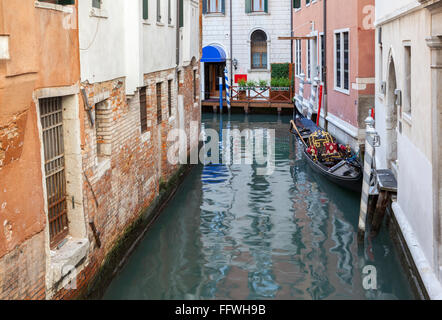 Ruhigen Gegend in Venedig mit einem festgemachten Gondel und Reflexionen von Altbauten Stockfoto