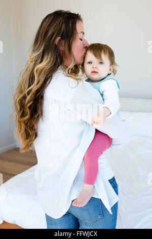 lächelnde Frau küssen eine entzückende baby Stockfoto