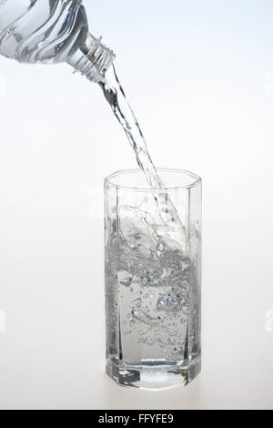 Gießen von Wasser in transparentem Kristallglas; Indien Stockfoto