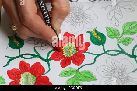 Zarte Frauenhand Erwachsenen Färbung der floralen Design, rot und grün, üben Umgang mit Stress zu tun. Stockfoto