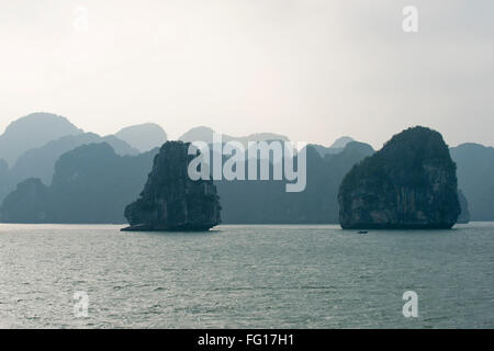 Nebligen Bild der zurückweichenden Kalkstein Karst oder Inseln steigt aus dem Meer in der Halong Bay, Nordvietnam, Stockfoto