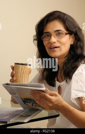 Mittelalter Frau mit Brille hält Zeitung und Becher 5. Juni 2010 Herr #686U Stockfoto