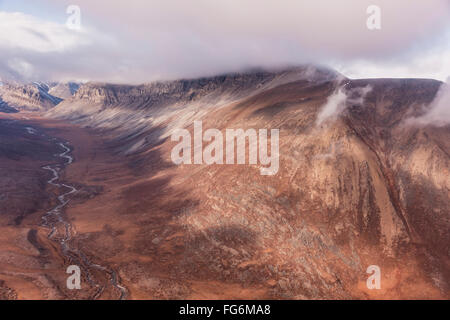 Luftaufnahme von niedrigen Wolken hängen am oberen Rand der Aushöhlung roter Klippen in der Brooks Range, Arktis, Alaska, USA, Sommer Stockfoto