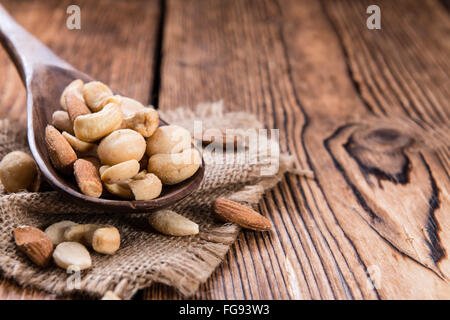 Teil des gemischten Nüssen (geröstet und gesalzen) auf einem alten Holztisch (Tiefenschärfe) Stockfoto