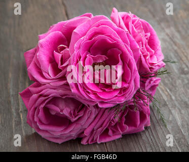 Rosa Rosen Blumen in einem Bouquet auf hölzernen Hintergrund Stockfoto