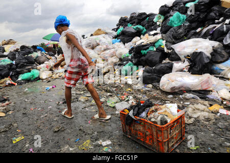 Junge (14) arbeitet in einer Mülltrennung und Weiterverkauf in einem Junk-e-Shop in der Nähe der Quezon City integrierte verschwenden Endlagers in Barangay (Dorf) Payatas in Quezon Stadt, Metro Manila, Philippinen Stockfoto