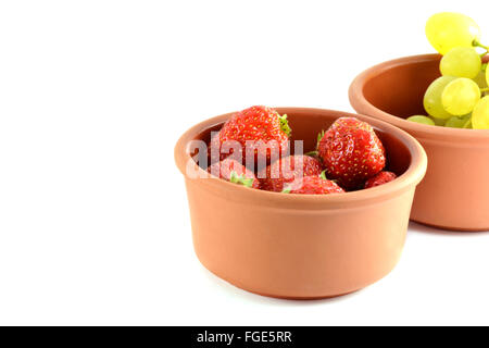 Trauben und Erdbeeren in einer Schüssel, isoliert auf weiss Stockfoto