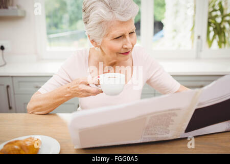 Ältere Frau liest eine Zeitung Stockfoto