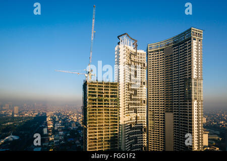 Wolkenkratzer und ein Gebäude im Bau in Makati, Metro Manila, Philippinen. Stockfoto