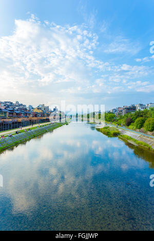 Menschen gemütlich ausruhen und Restaurants säumen das Ufer des Kamo-Flusses an einem späten Nachmittag an einem Tag blauer Himmel in zentralen Kyoto Stockfoto