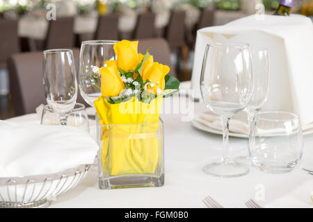 Tisch im Restaurant zubereiten für Parteien, haben die gelbe rose, grauer Stuhl und Weinflasche im Korb Stockfoto