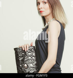 Elegante modische Frau mit Handtasche aus Leder. Stilvolle Mädchen halten schwarze Tasche. Mode. Stockfoto