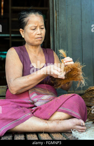 Frau arbeitet mit Cocos Fasern, Burma Stockfoto