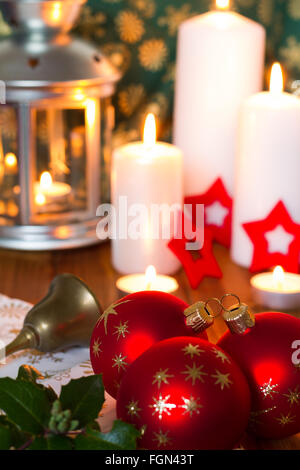 Rote Weihnachtskugeln mit Kerzen und roten Sternen Stockfoto