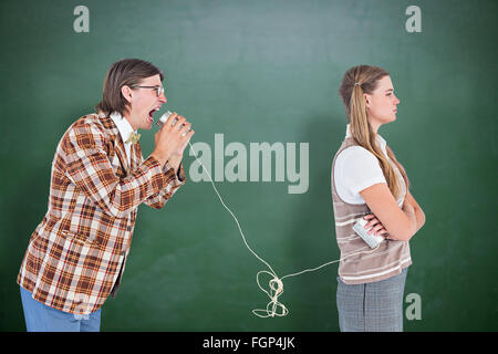 Zusammengesetztes Bild von geeky Hipster mit Schnur-Telefon Stockfoto