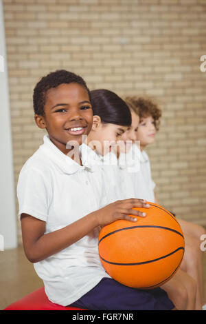 Student mit Basketball mit Mitspielern Stockfoto