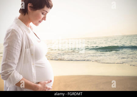 Zusammengesetztes Bild entspannte schwangere Frau mit Augen schließen Stockfoto