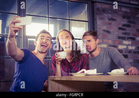 Grimassierende Freunde unter selfies Stockfoto