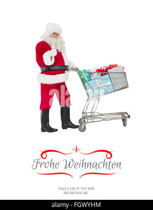 Zusammengesetztes Bild des positiven Santa, die Geschenke mit einem Trolley zu liefern Stockfoto