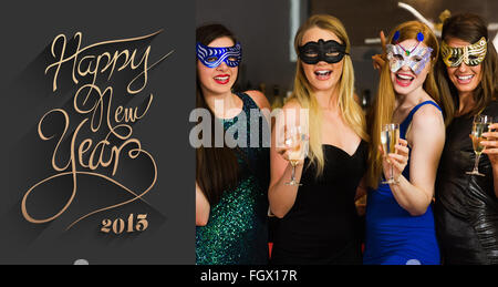 Zusammengesetztes Bild des Lachens Freunde tragen Masken Holding Champagner Gläser Stockfoto