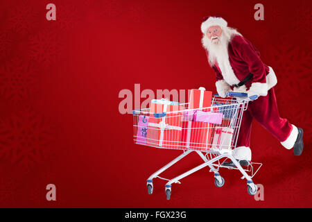 Zusammengesetztes Bild von Santa reitet auf einem Einkaufswagen Stockfoto