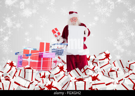 Zusammengesetztes Bild von Santa, die Geschenke aus dem Warenkorb zu liefern Stockfoto