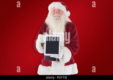 Zusammengesetztes Bild von Santa präsentiert einen TabletPC Stockfoto