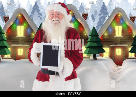 Zusammengesetztes Bild von Santa präsentiert einen TabletPC Stockfoto