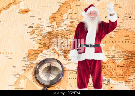 Zusammengesetztes Bild von jolly Santa winken in die Kamera Stockfoto