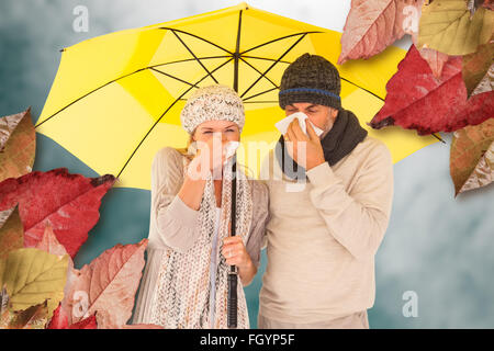 Zusammengesetztes Bild von paar Niesen im Gewebe stehen unter Dach Stockfoto